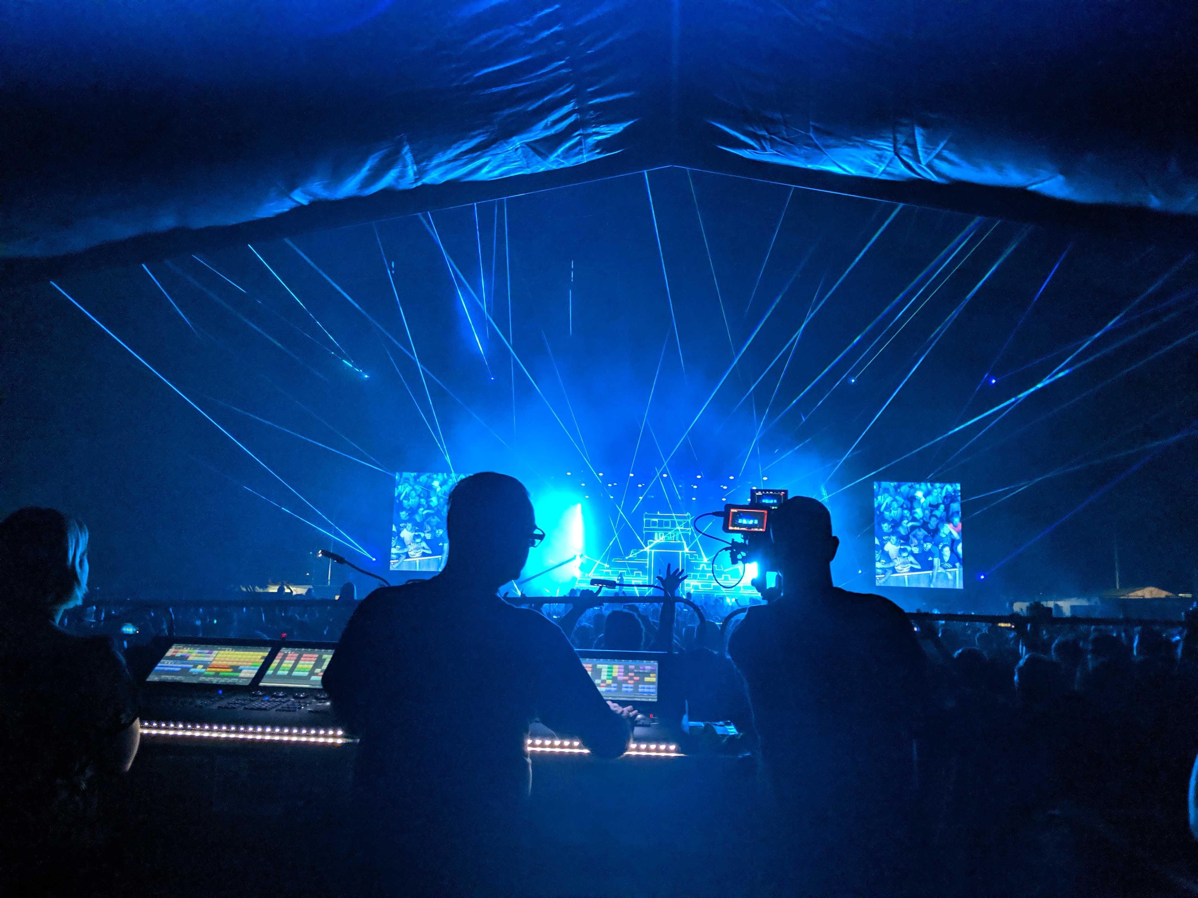 FOH crew operating LED and video at an outdoor festival