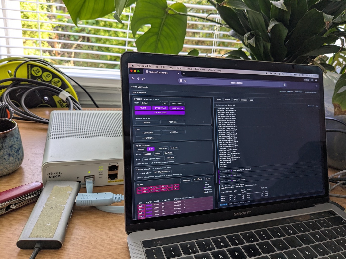 Cisco switch under test with Switch Commander on a laptop