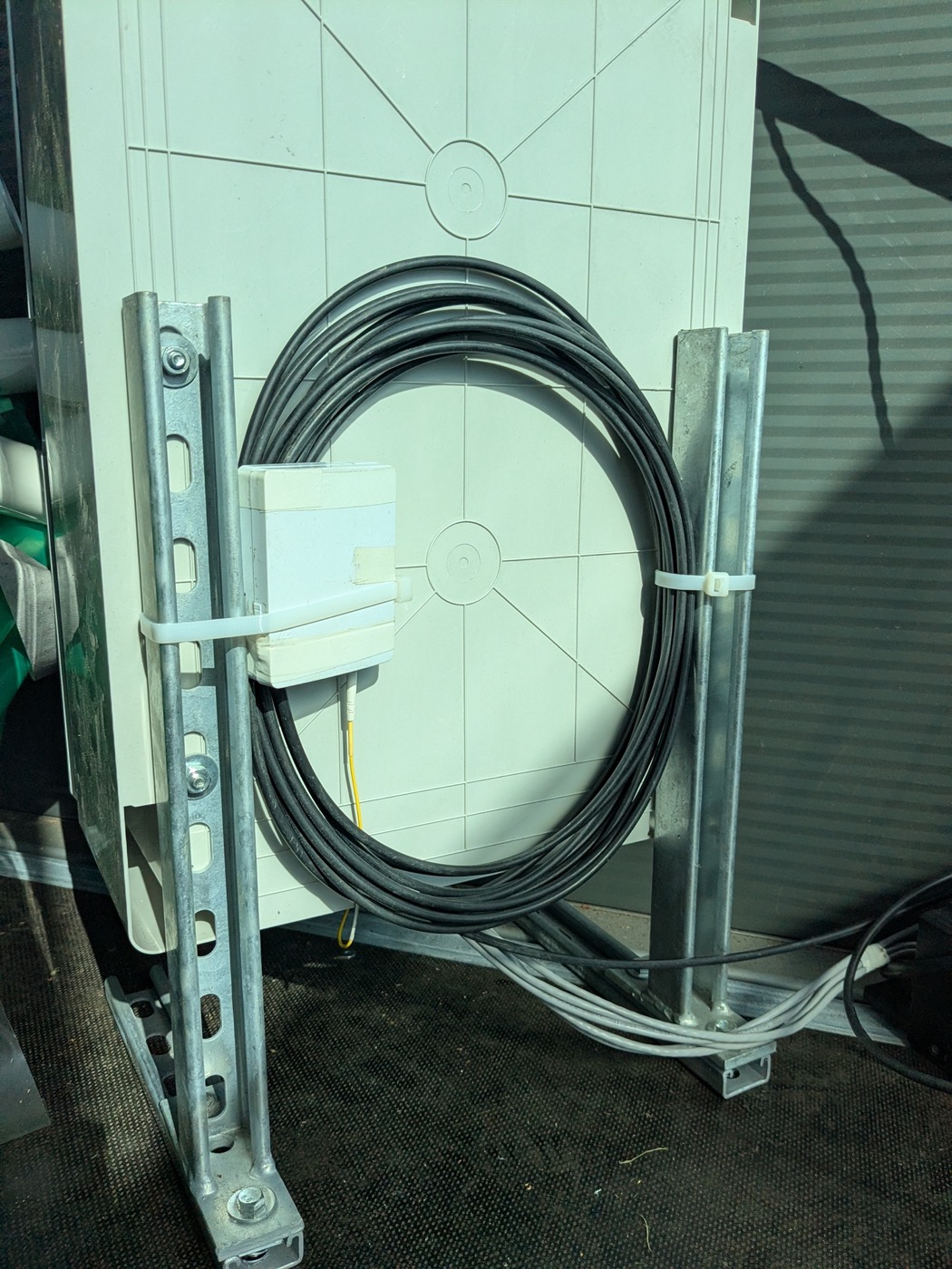 Coiled fibre and copper cabling dressed on a frame