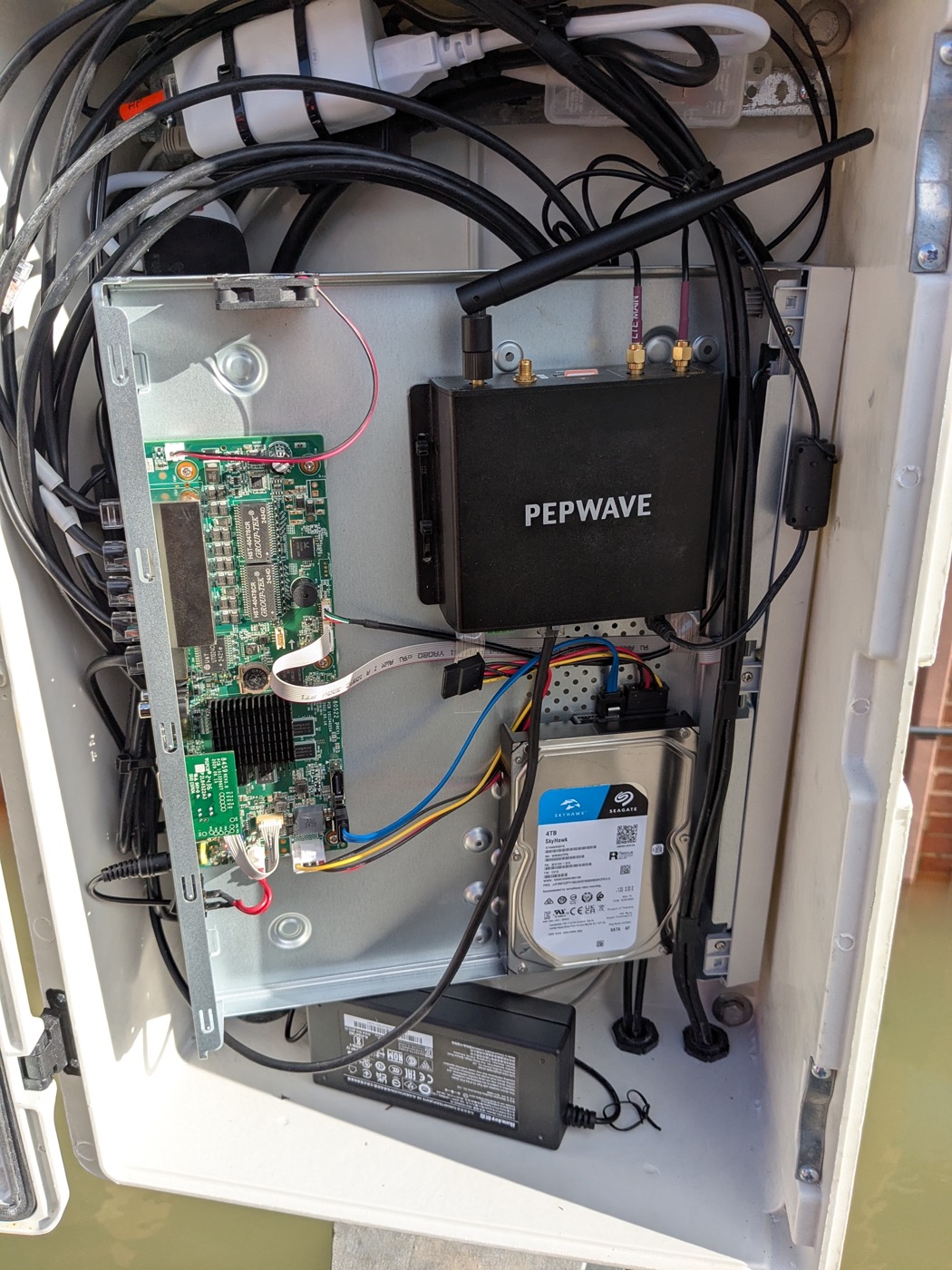Pepwave cellular router installed in a weatherproof cabinet