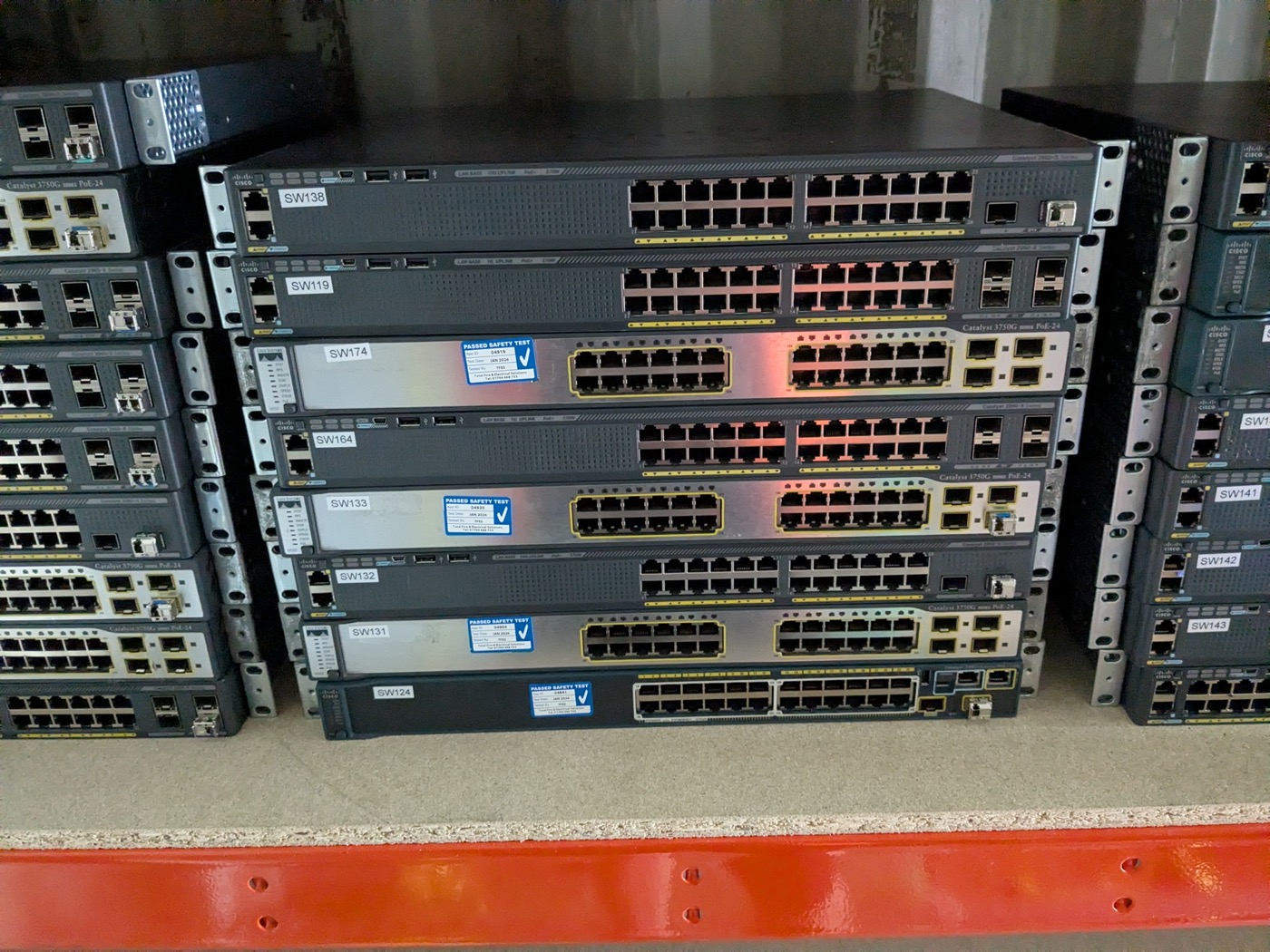 Stack of labelled Cisco Catalyst switches ready for deployment